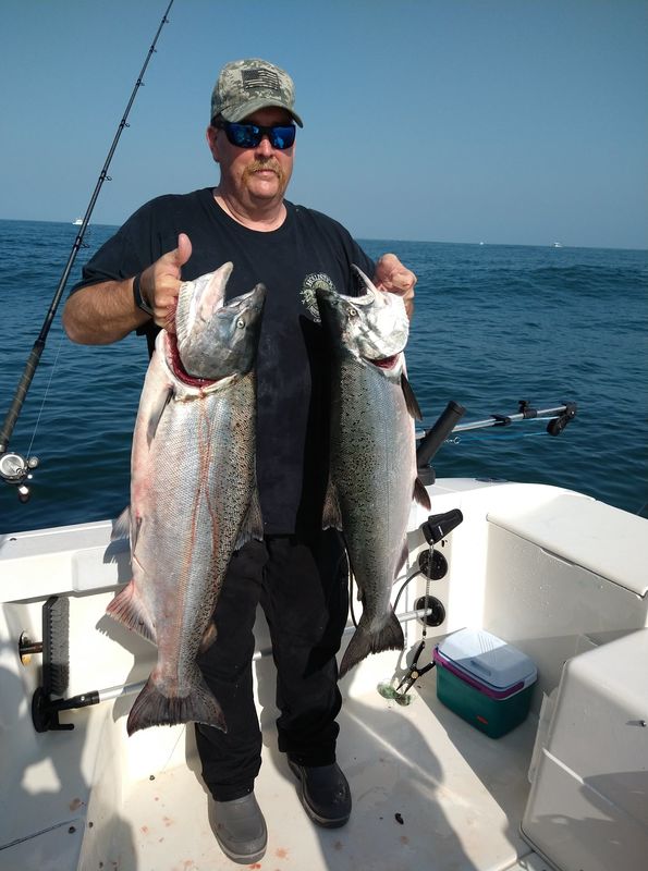 My friend and skipper, John, with his catch for th...